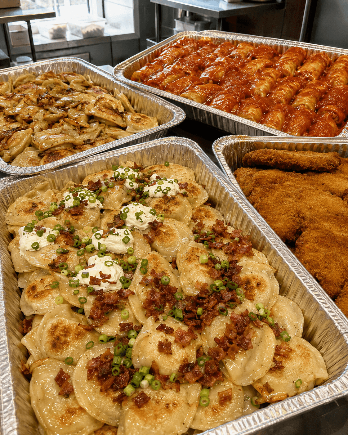 A large Pierogi House catering order with trays of pierogi, cabbage rolls, and schnitzels